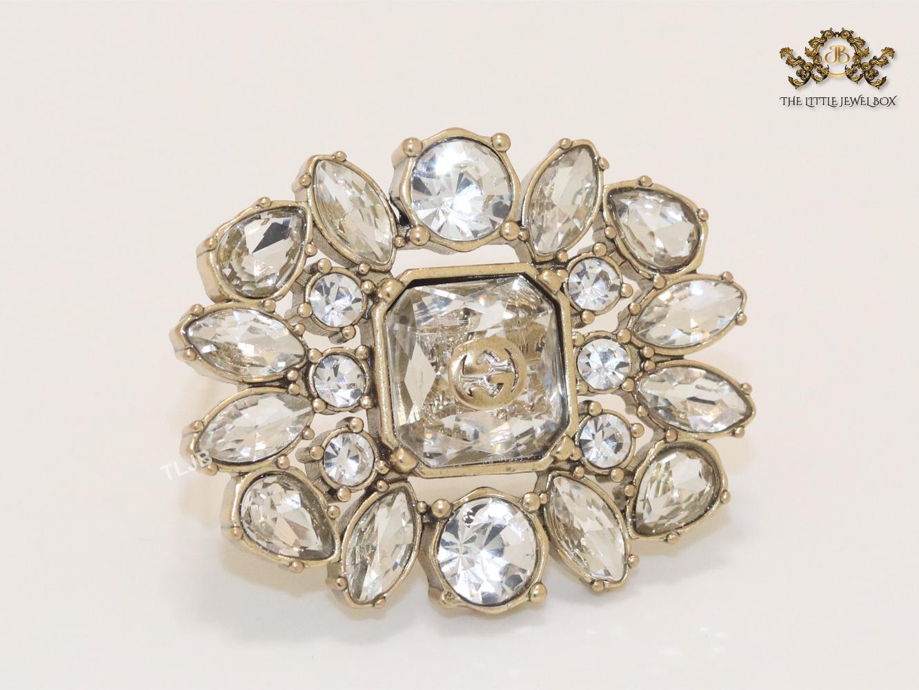 Double G brooch with uncut stones