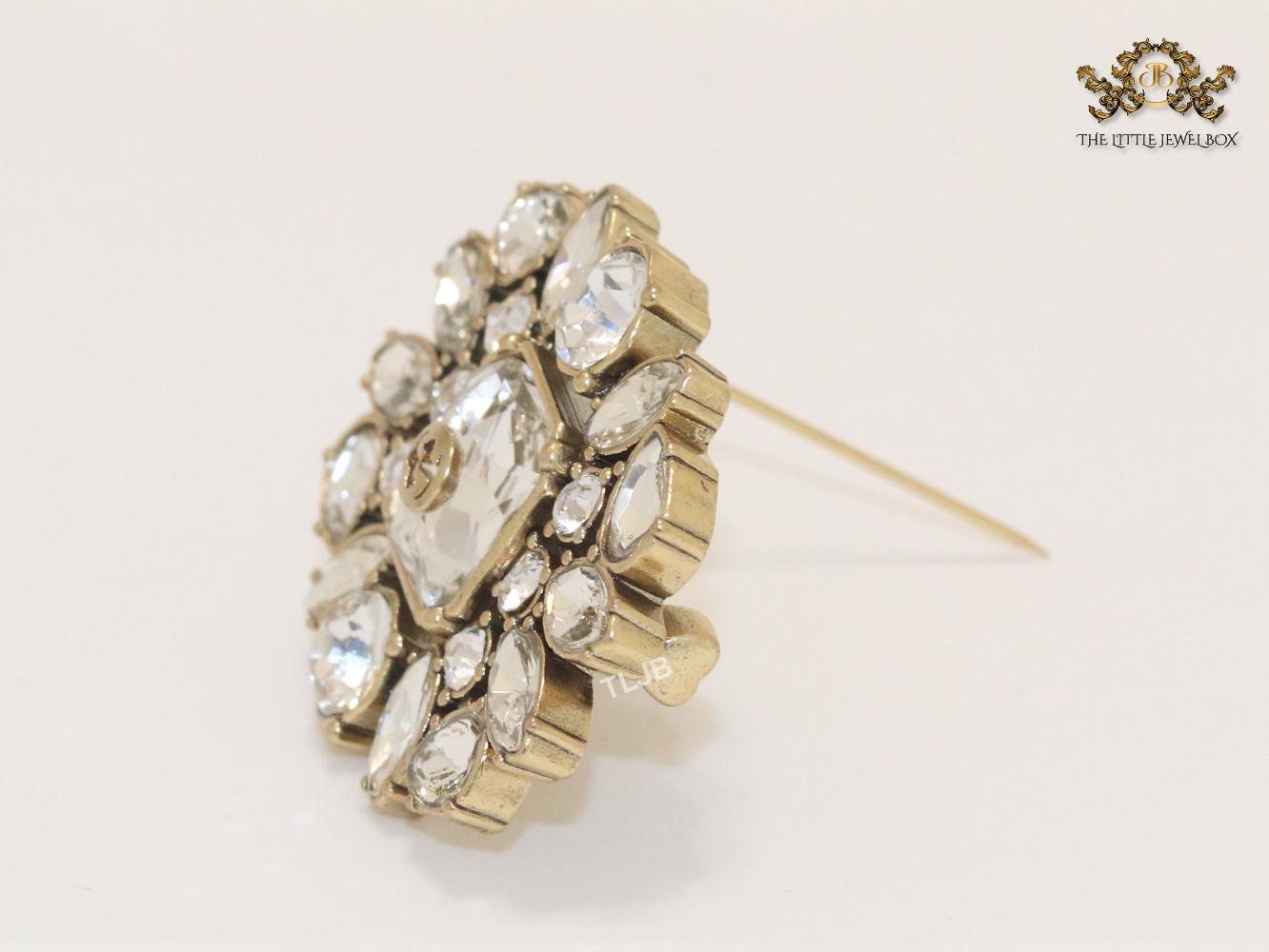 Double G brooch with uncut stones