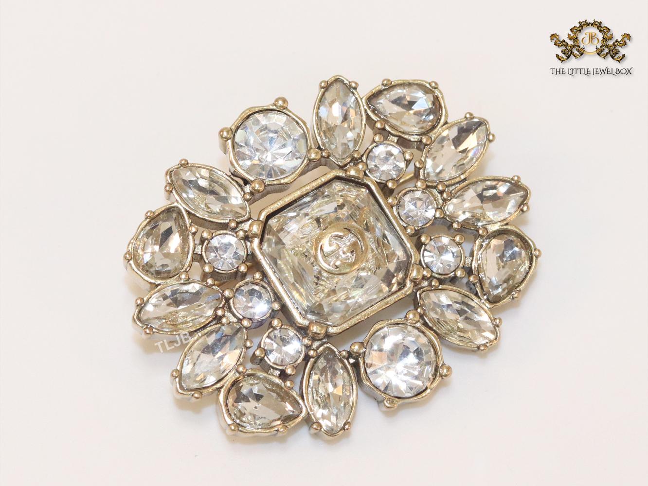 Double G brooch with uncut stones