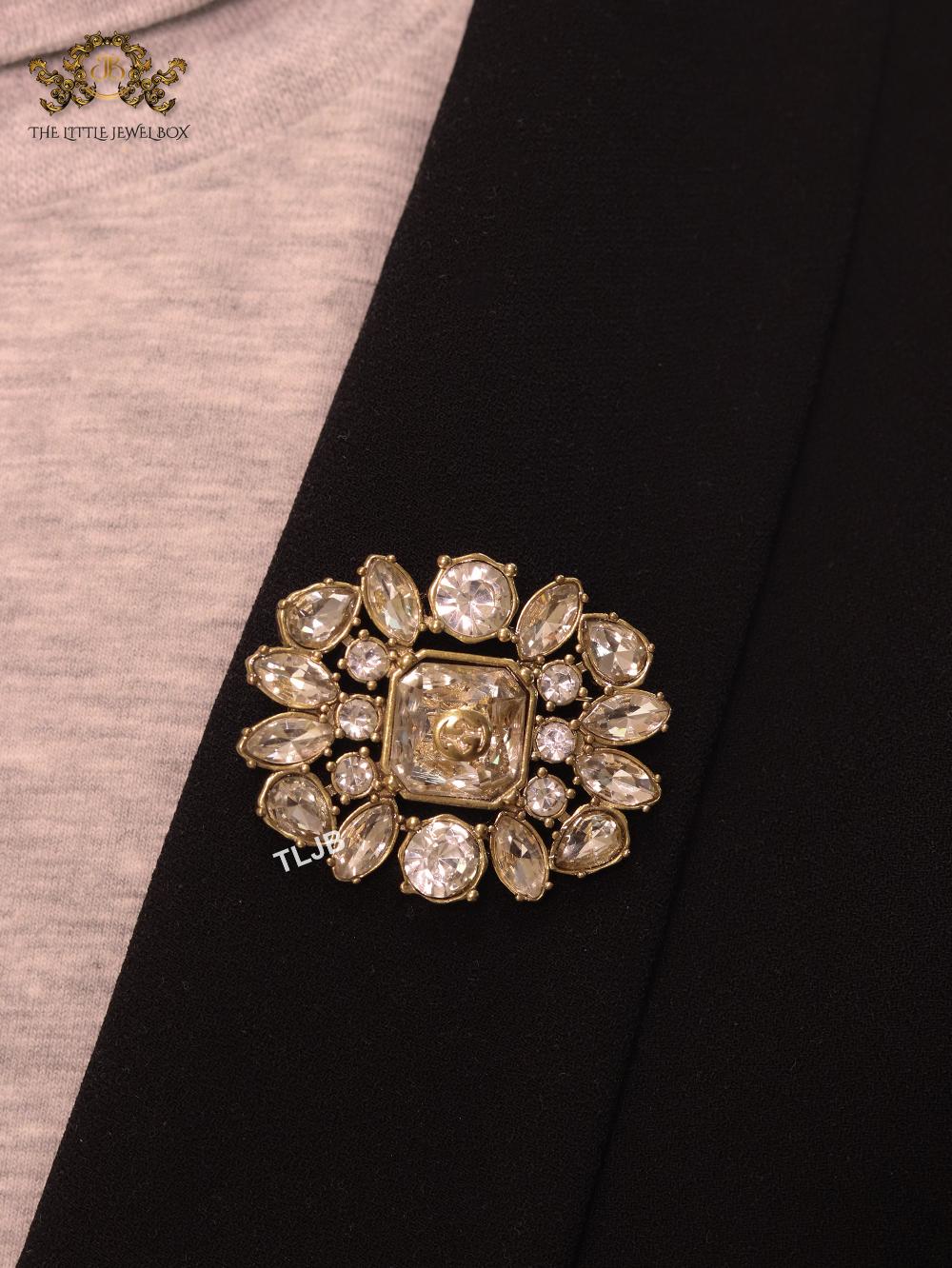 Double G brooch with uncut stones