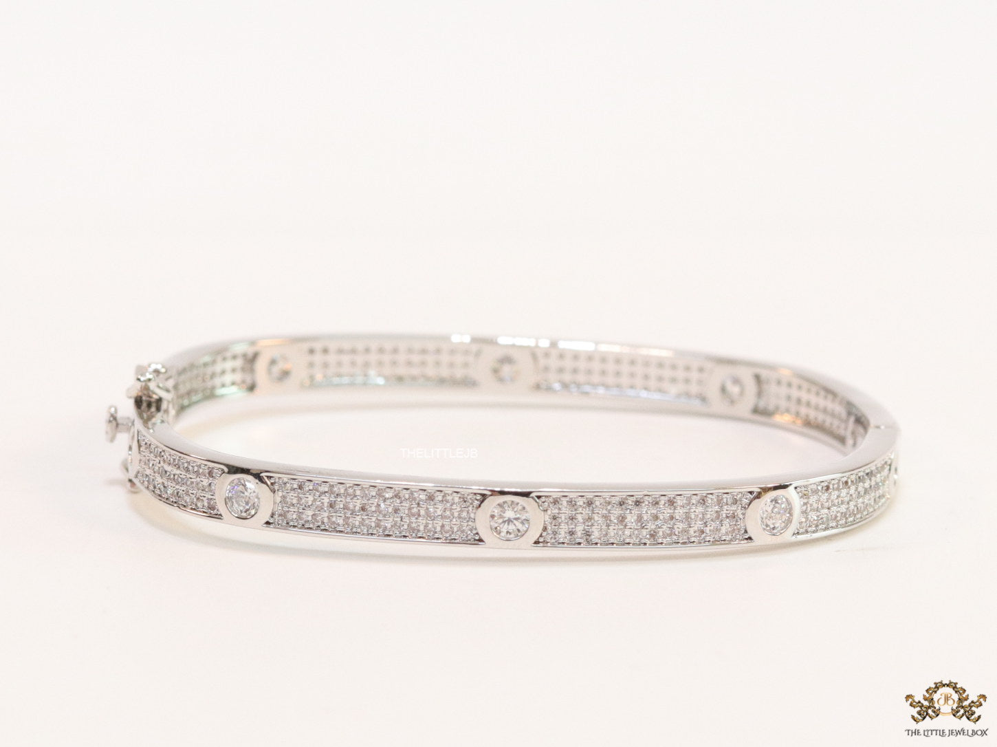 Platinum plated openable bracelet studded with cz