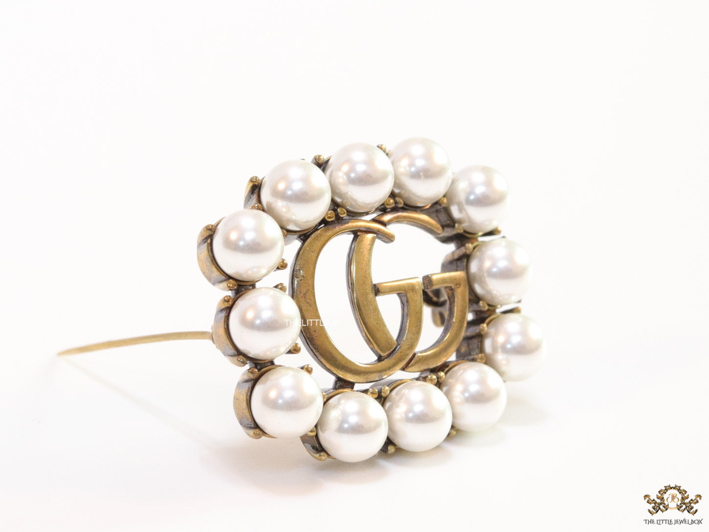Pearls embraced alphabet brooch in gold finish