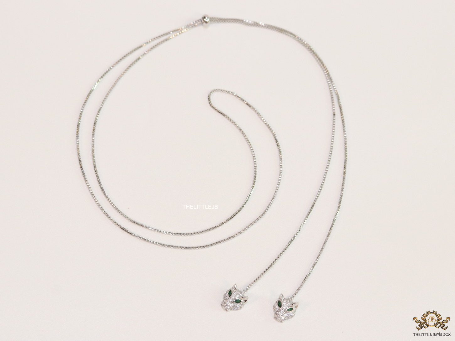 Platinum plated knot necklace with twin cz panther pendants
