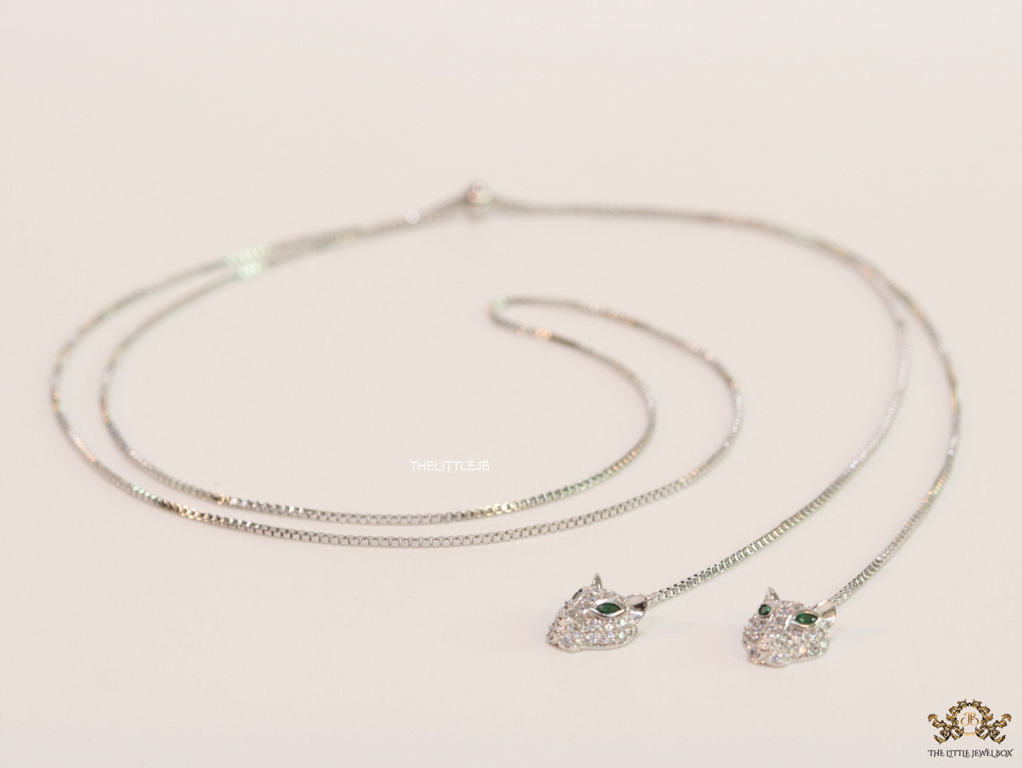 Platinum plated knot necklace with twin cz panther pendants