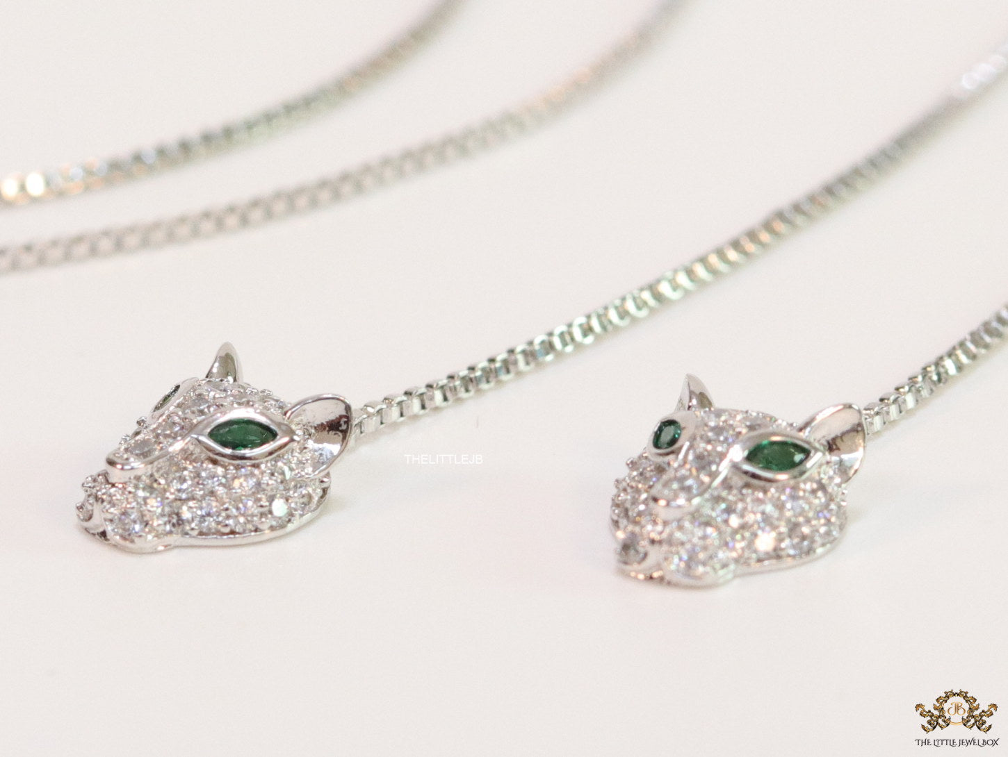 Platinum plated knot necklace with twin cz panther pendants