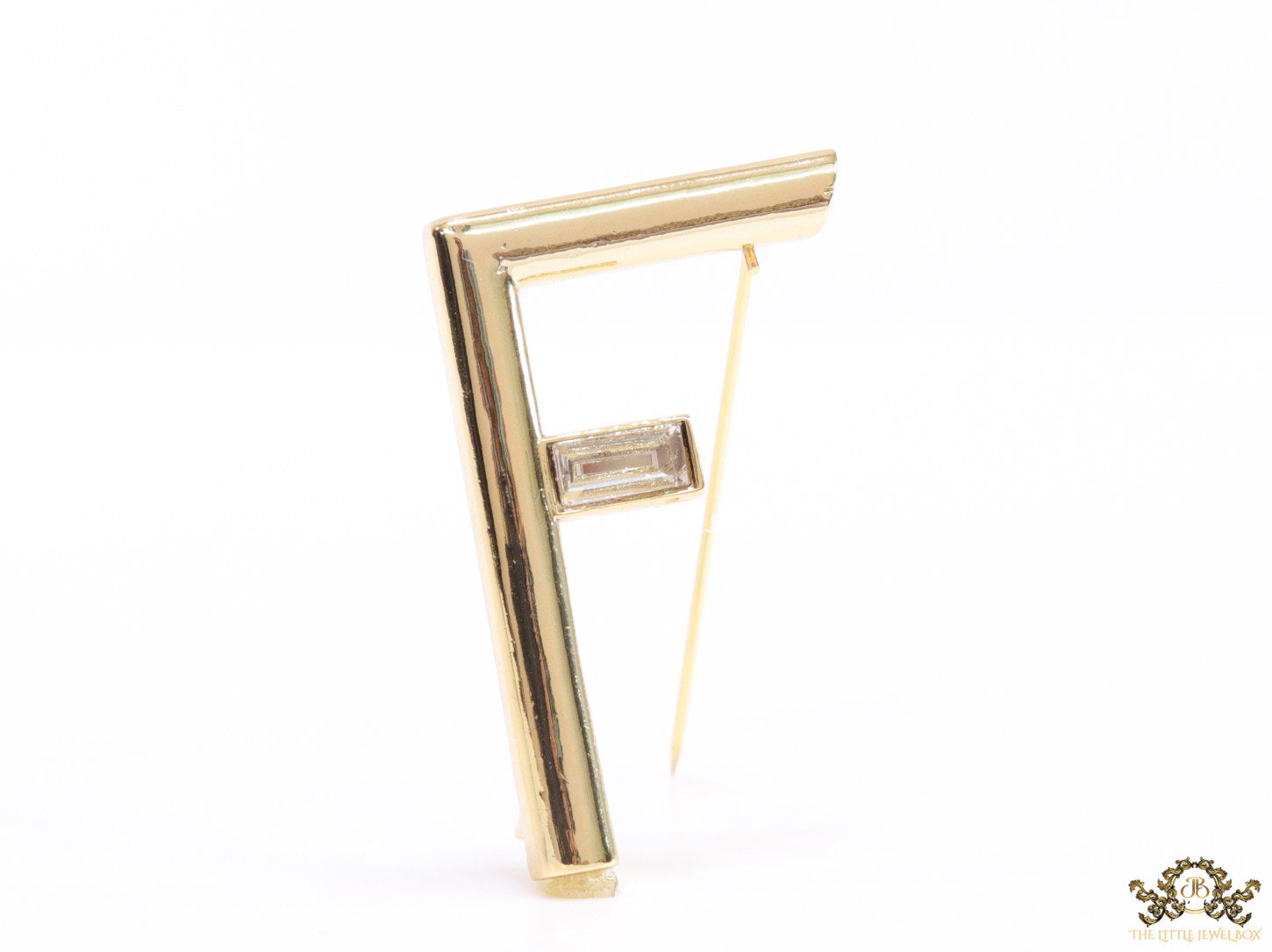 Gold plated alphabet F brooch with baguette cubic zirconia stone