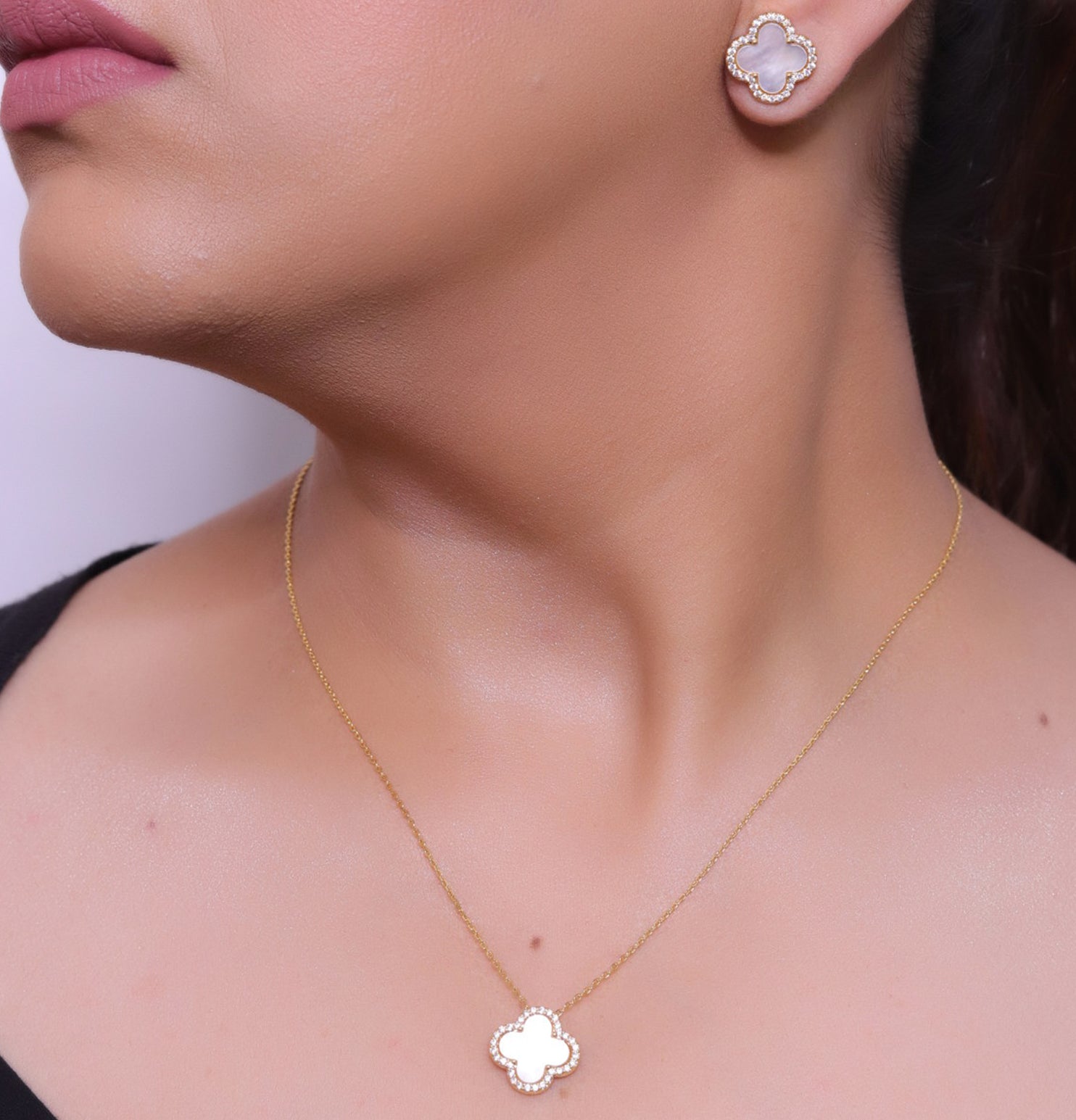 Sleek gold plated chain with cubic zirconia studded off-white clover shape pendant