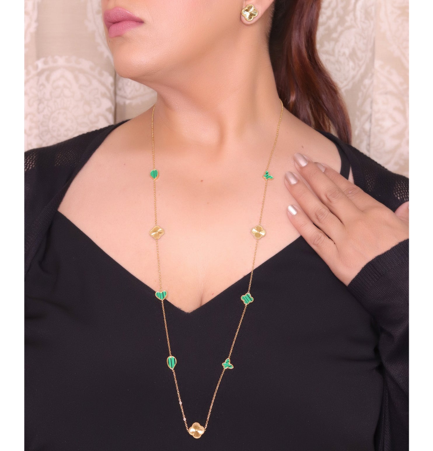 Emerald green clover heart and other shape charms on a sleek long gold plated chain with matching studs