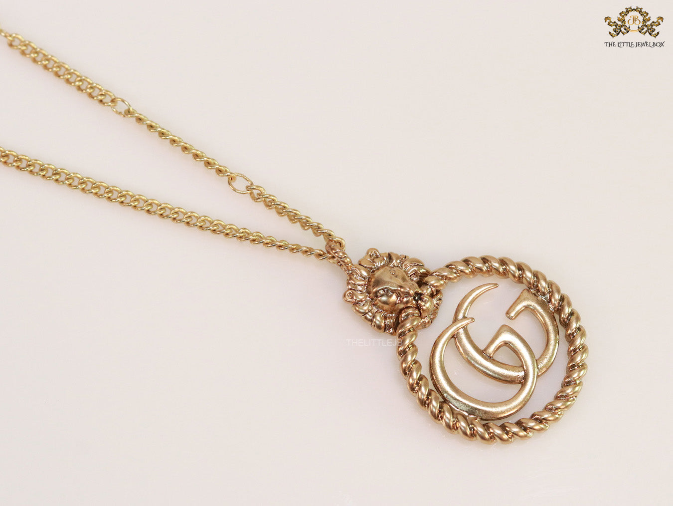 Gold plated lion face and double G initial necklace
