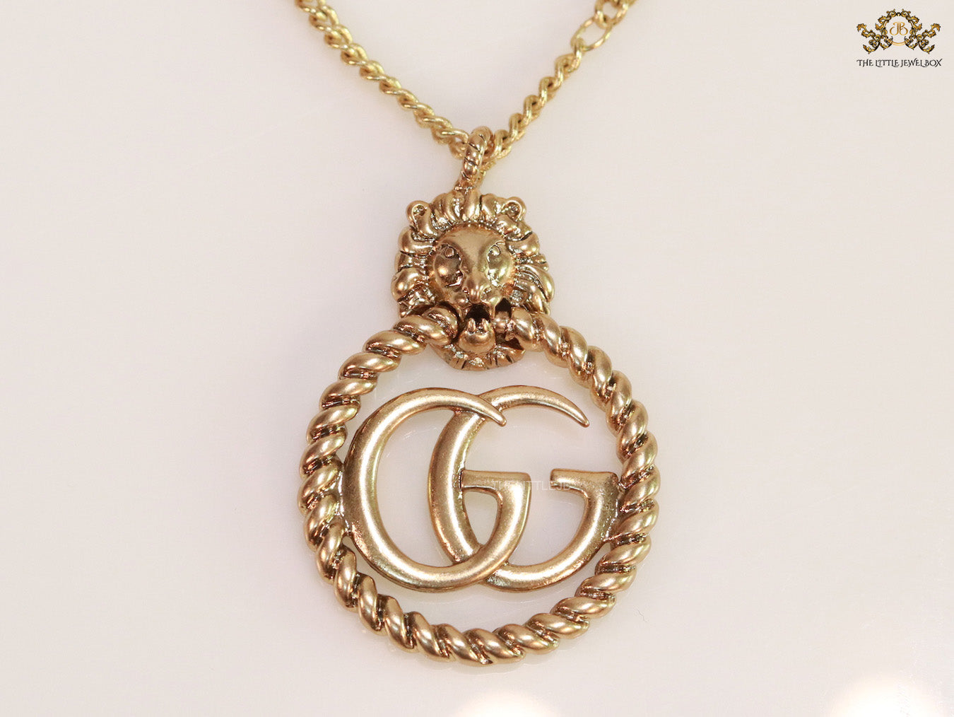 Gold plated lion face and double G initial necklace