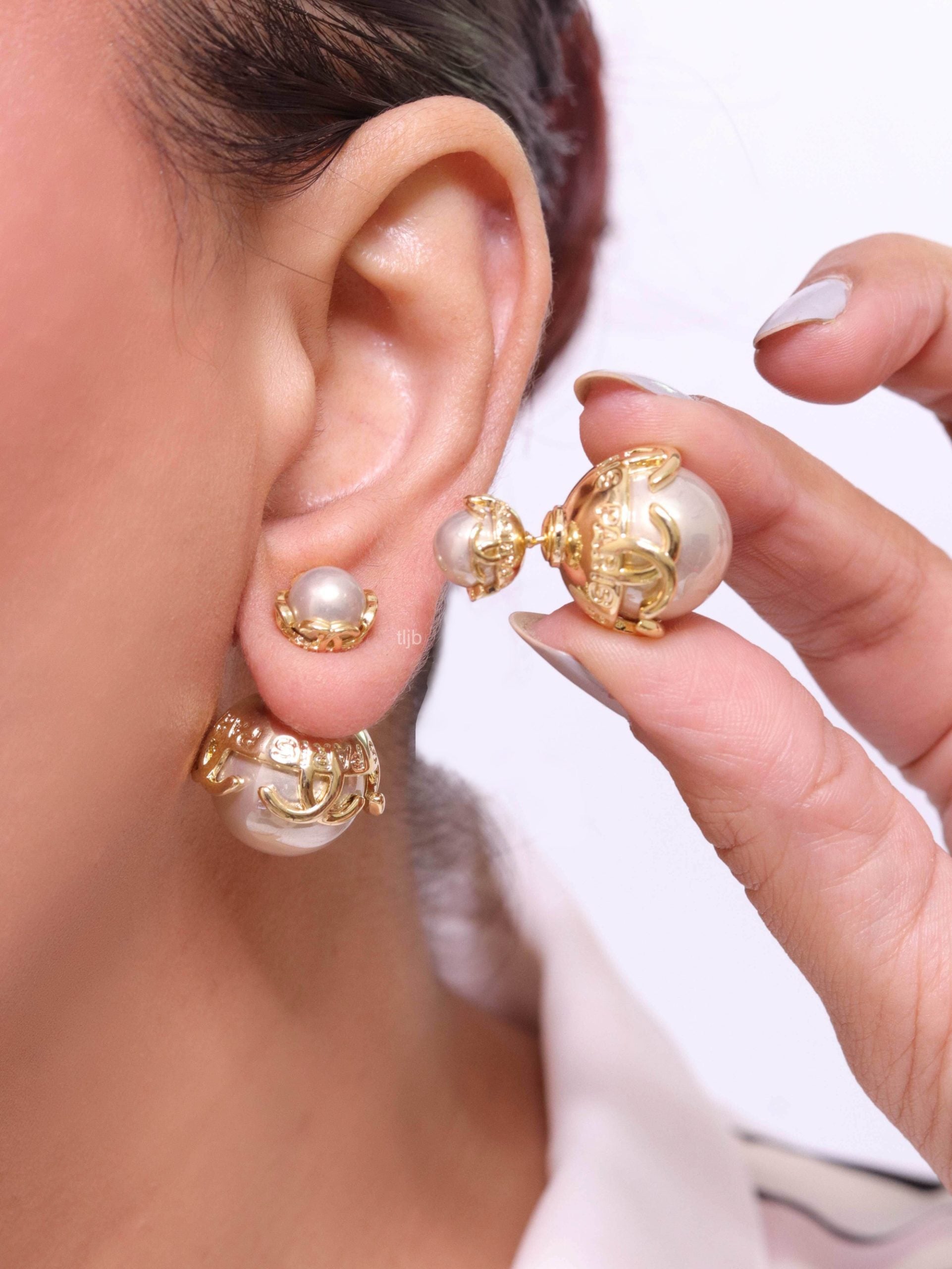 Double C white pearl studs in gold finish