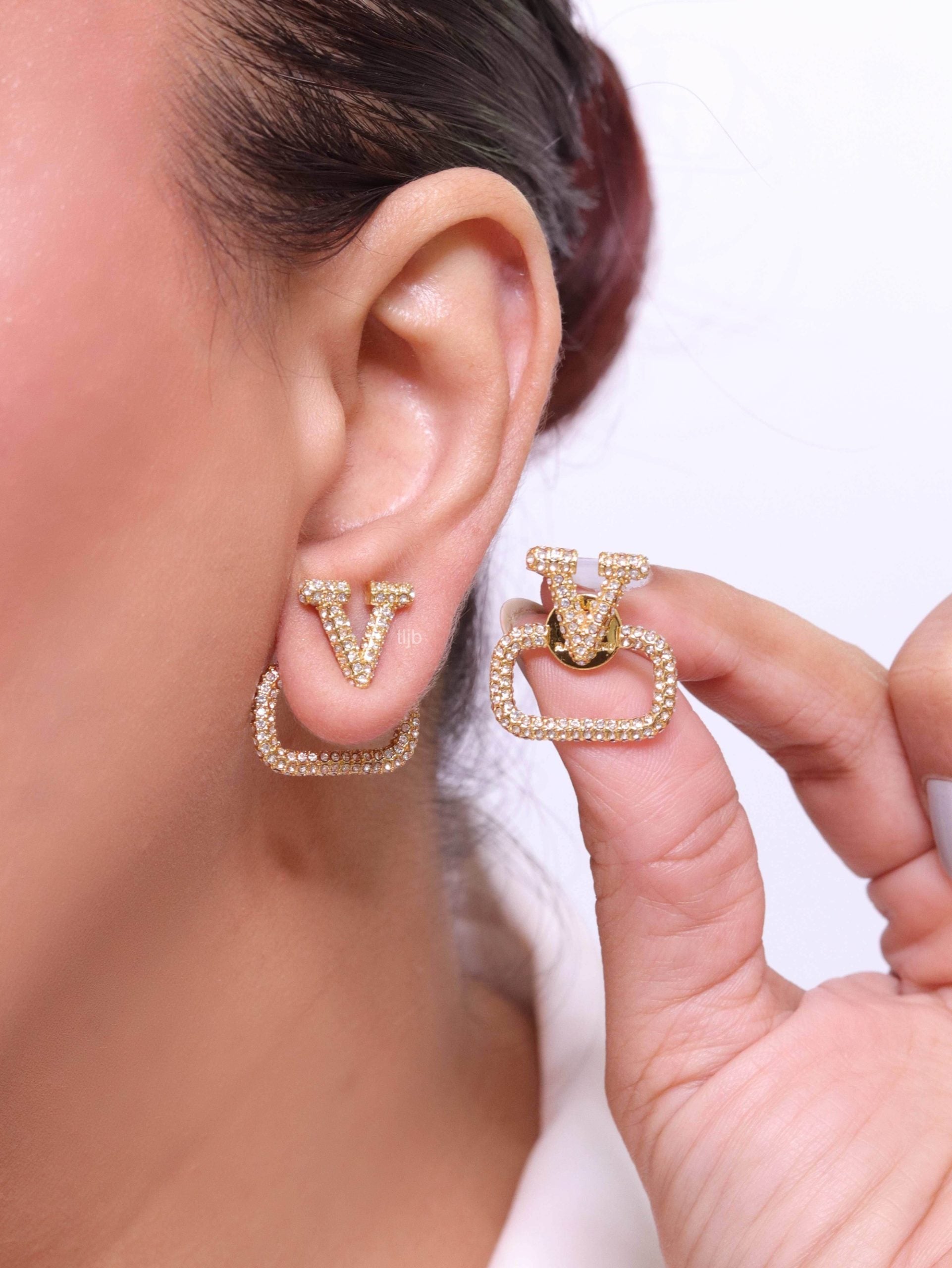 Alphabet V cz studs in gold finish