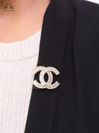 Gold finish Double C alphabet brooch with cz baguette