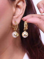 Alphabet V pearl dangling studs in gold finish
