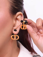 Black and Orange alphabet C and D stud in gold finish