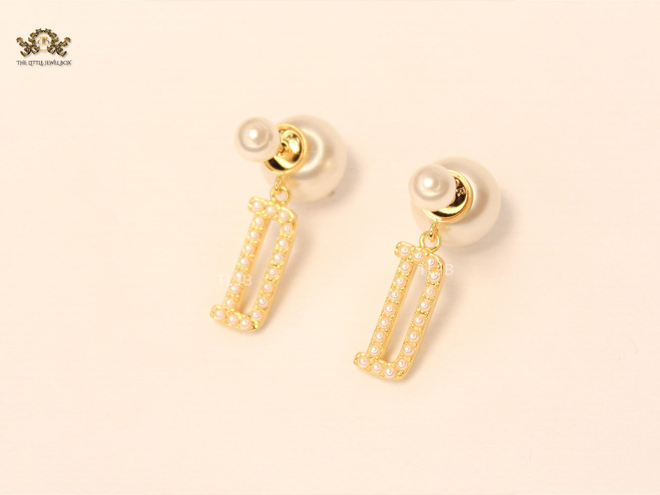 alphabet D pearl studded bomber earrings