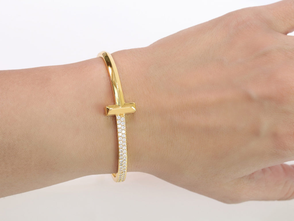 Alphabet T bracelet with half CZ in gold finish