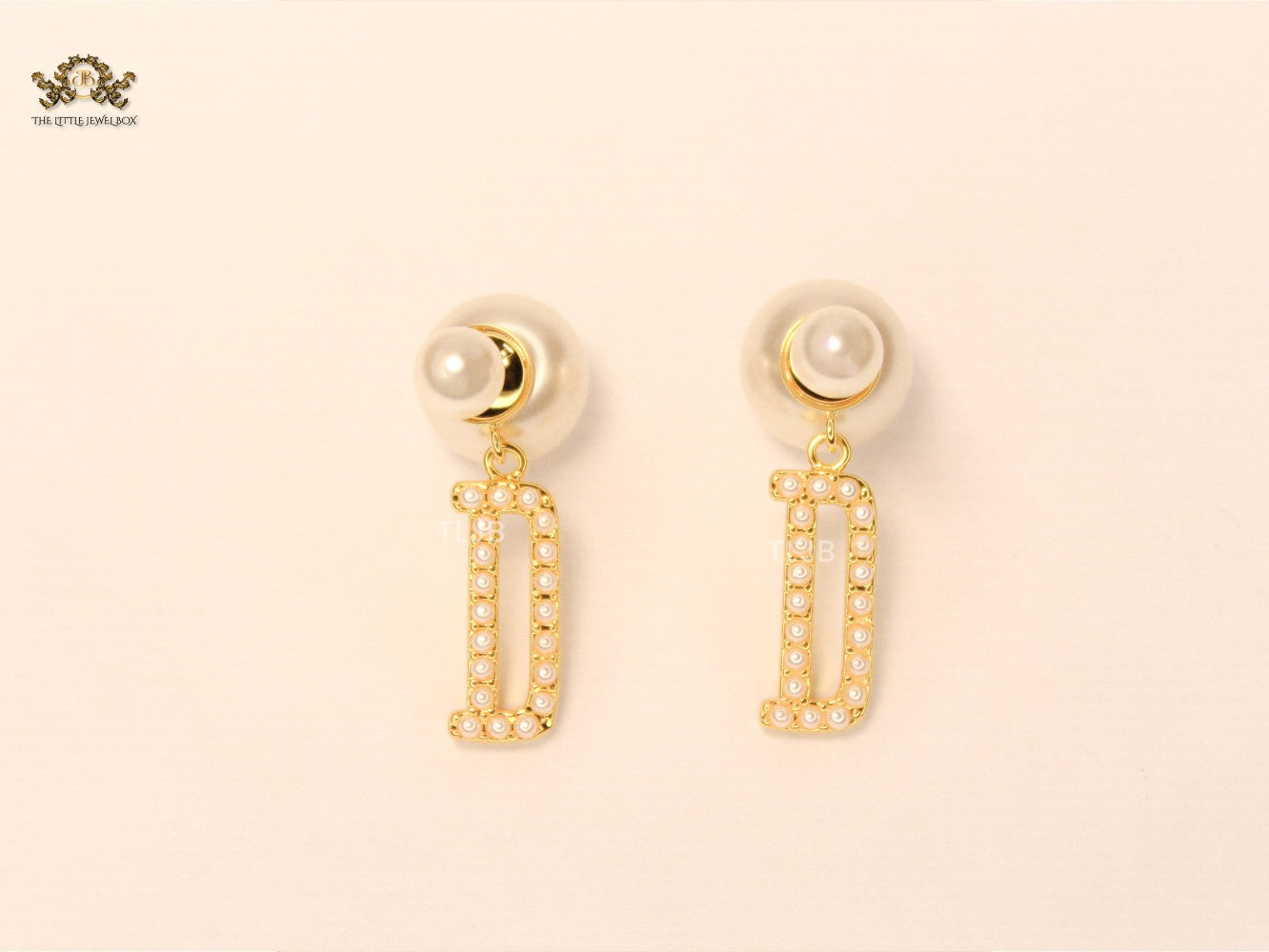alphabet D pearl studded bomber earrings