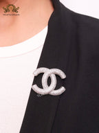Platinum plated double C alphabet brooch with tiny cubic zirconia stones