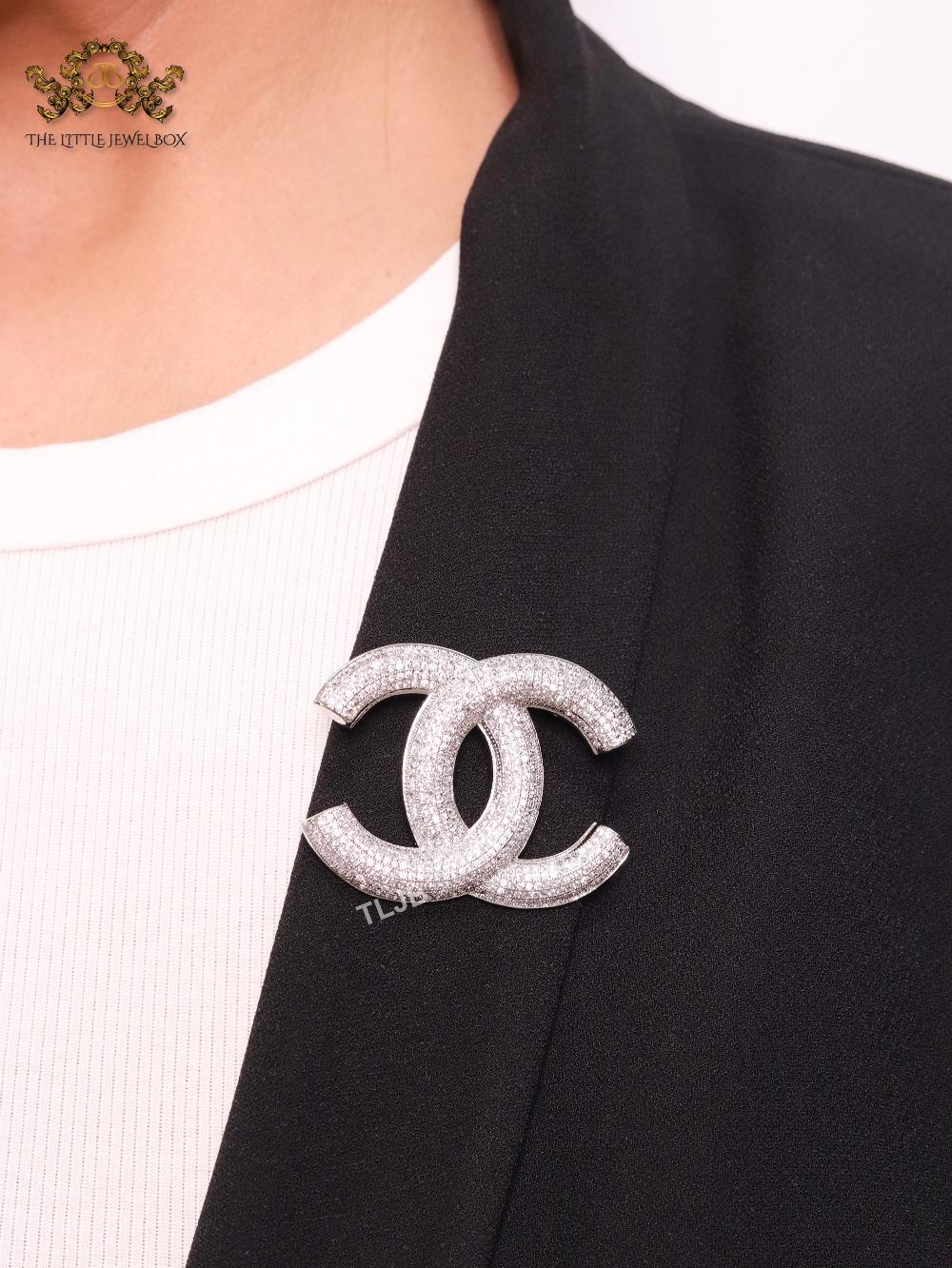 Platinum plated double C alphabet brooch with tiny cubic zirconia stones
