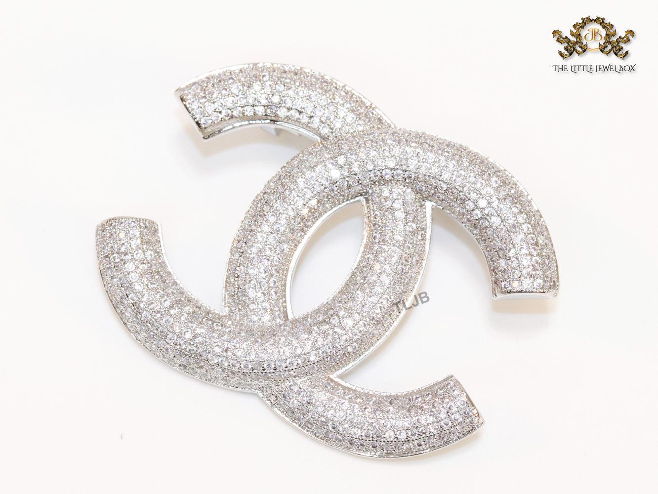 Platinum plated double C alphabet brooch with tiny cubic zirconia stones