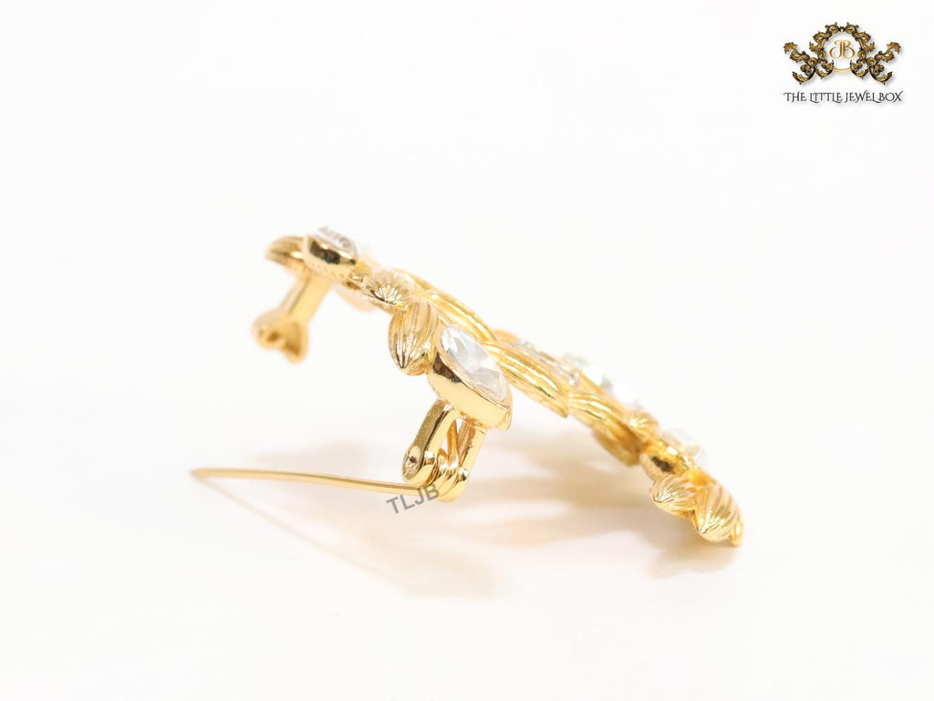 Twin C brooch in matte gold and fancy cz