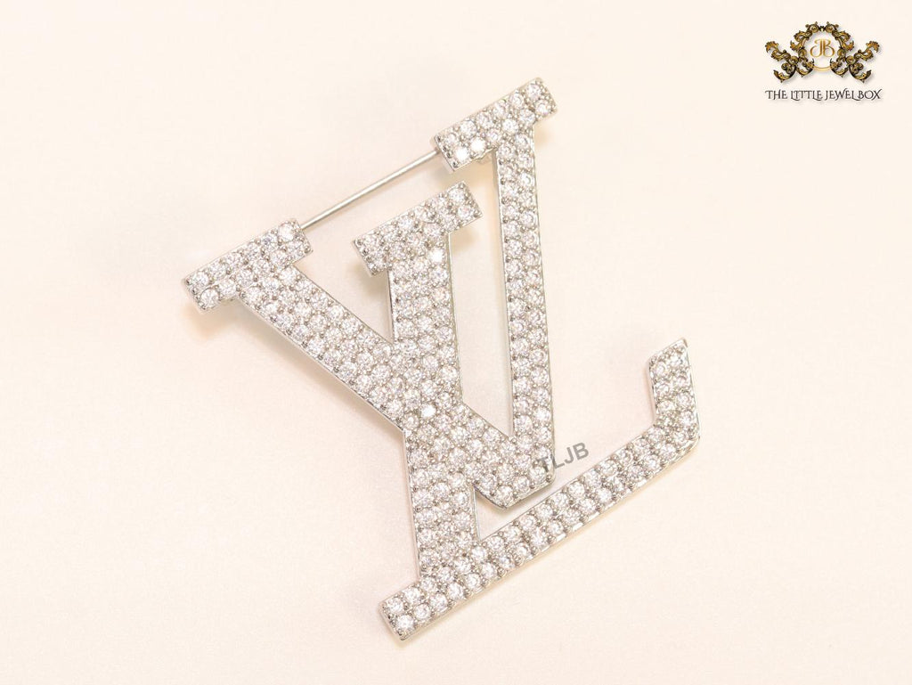 Stylish Land V brooch in cz and platinum finish