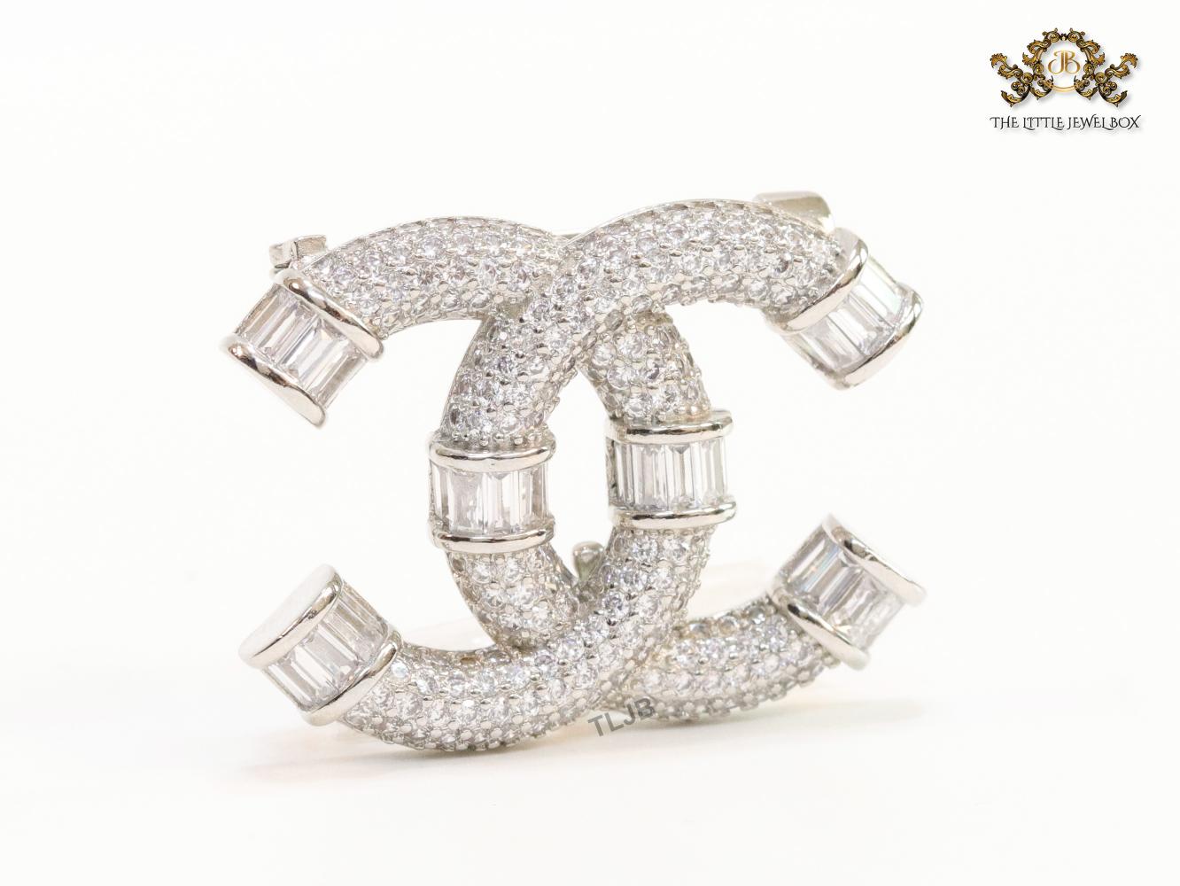 Platinum plated twin C brooch with cz baguettes