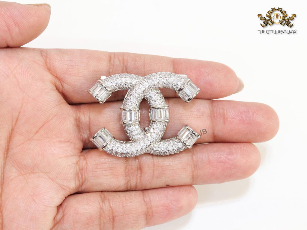 Platinum plated twin C brooch with cz baguettes