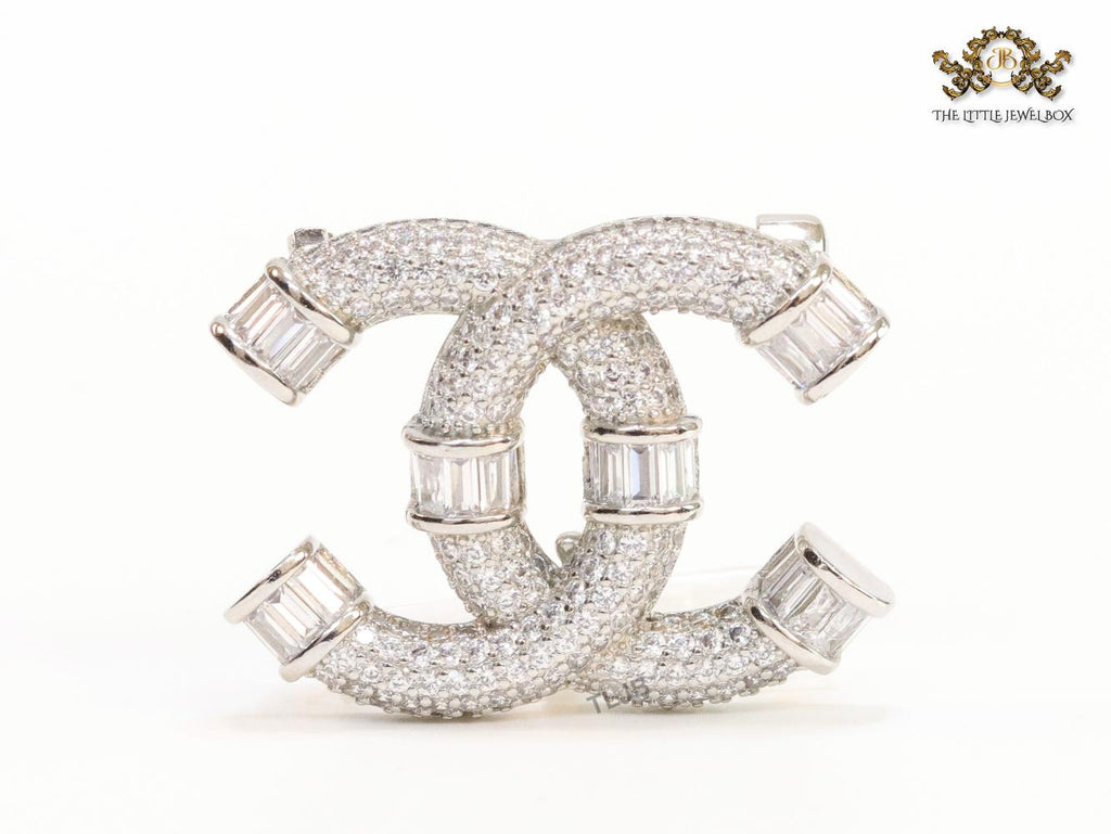 Platinum plated twin C brooch with cz baguettes
