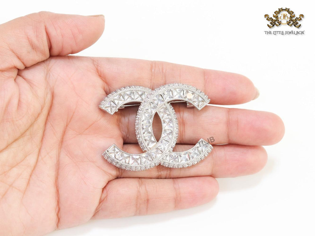 Platinum plated twin C brooch with fancy cut cz
