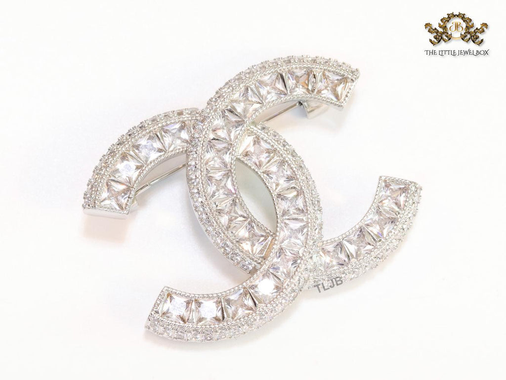 Platinum plated twin C brooch with fancy cut cz