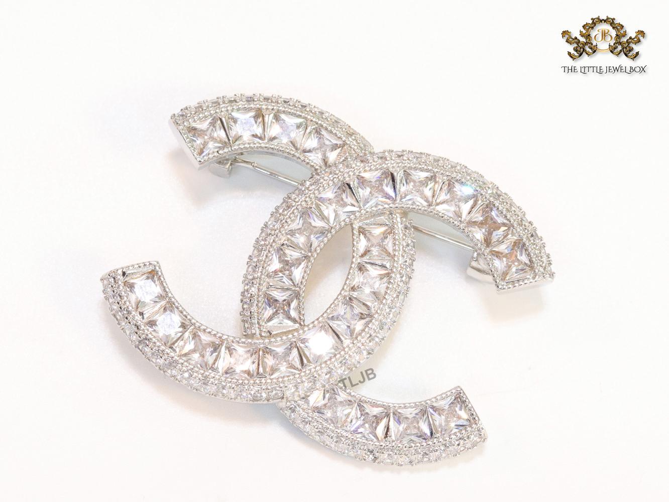 Platinum plated twin C brooch with fancy cut cz