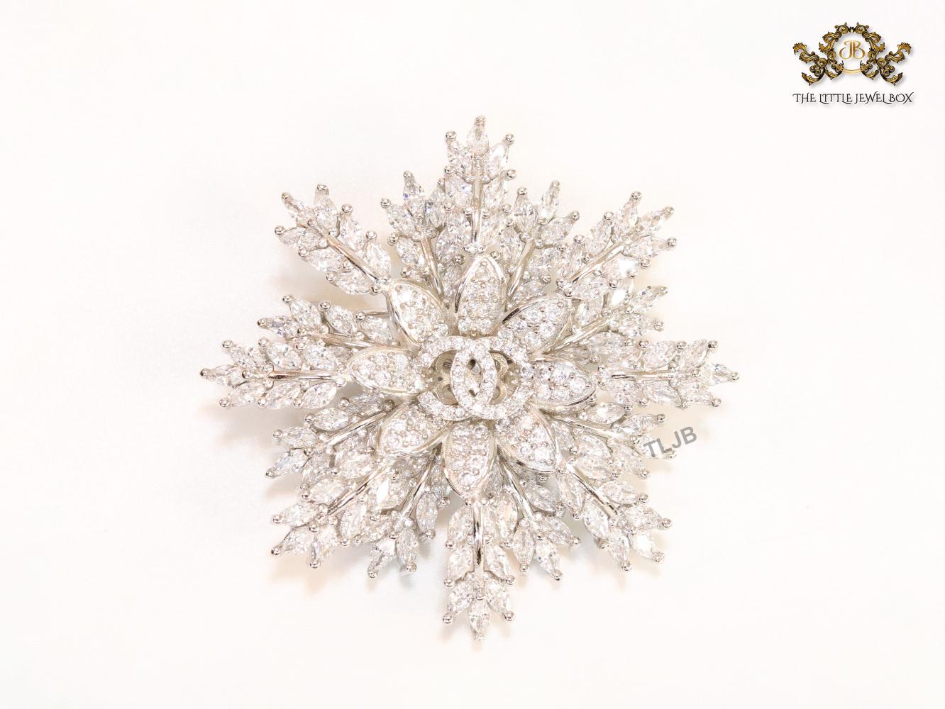 Flower and leaf brooch in platinum finish and cz