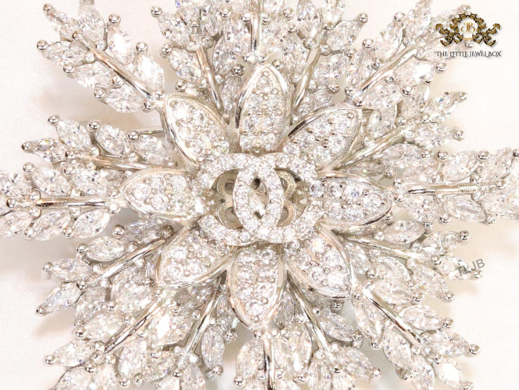 Flower and leaf brooch in platinum finish and cz