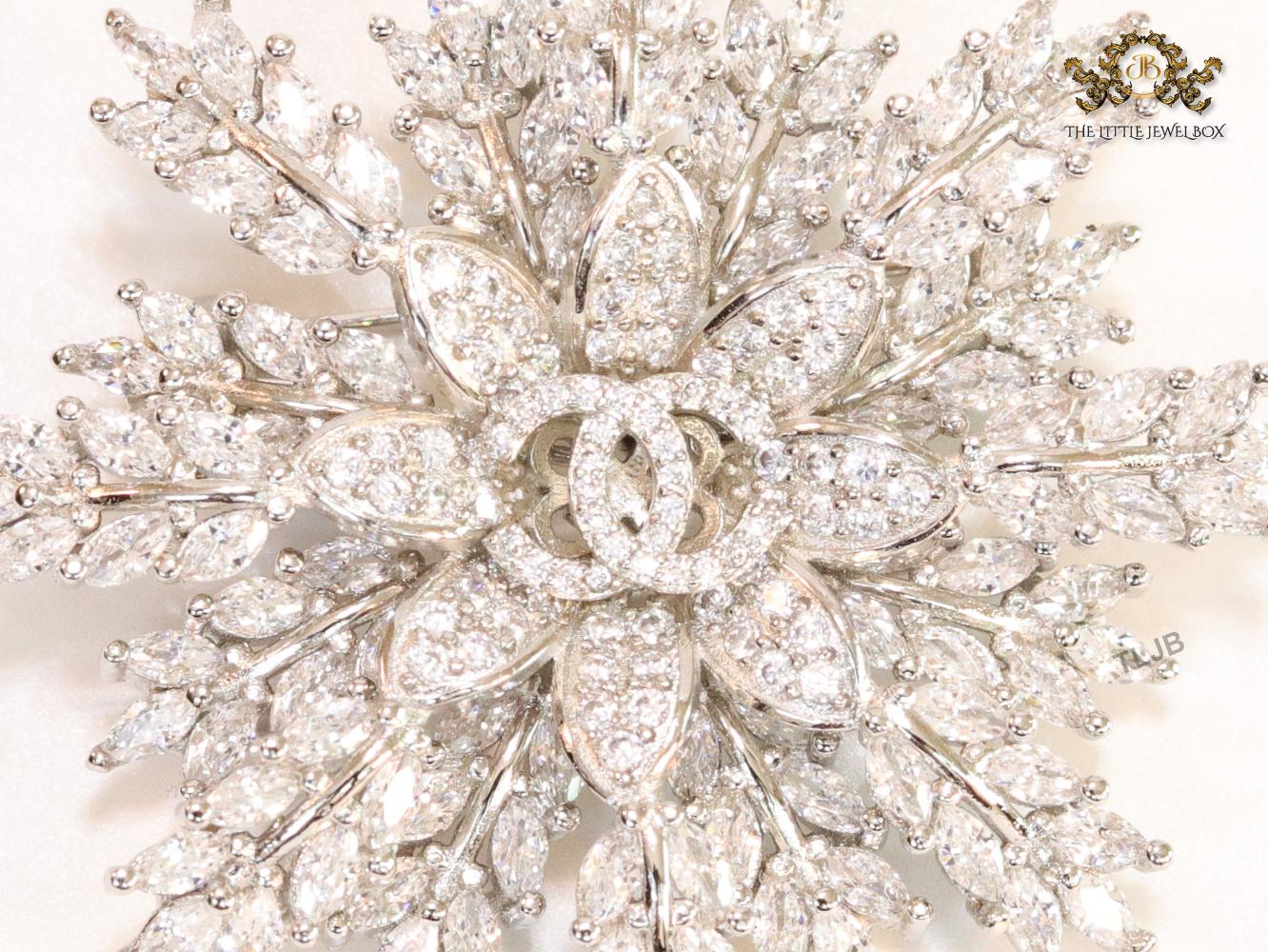 Flower and leaf brooch in platinum finish and cz