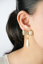 Alphabet V Bow Motif Long Pearl Dangler with CZ in Gold | Elegant Drop Earrings