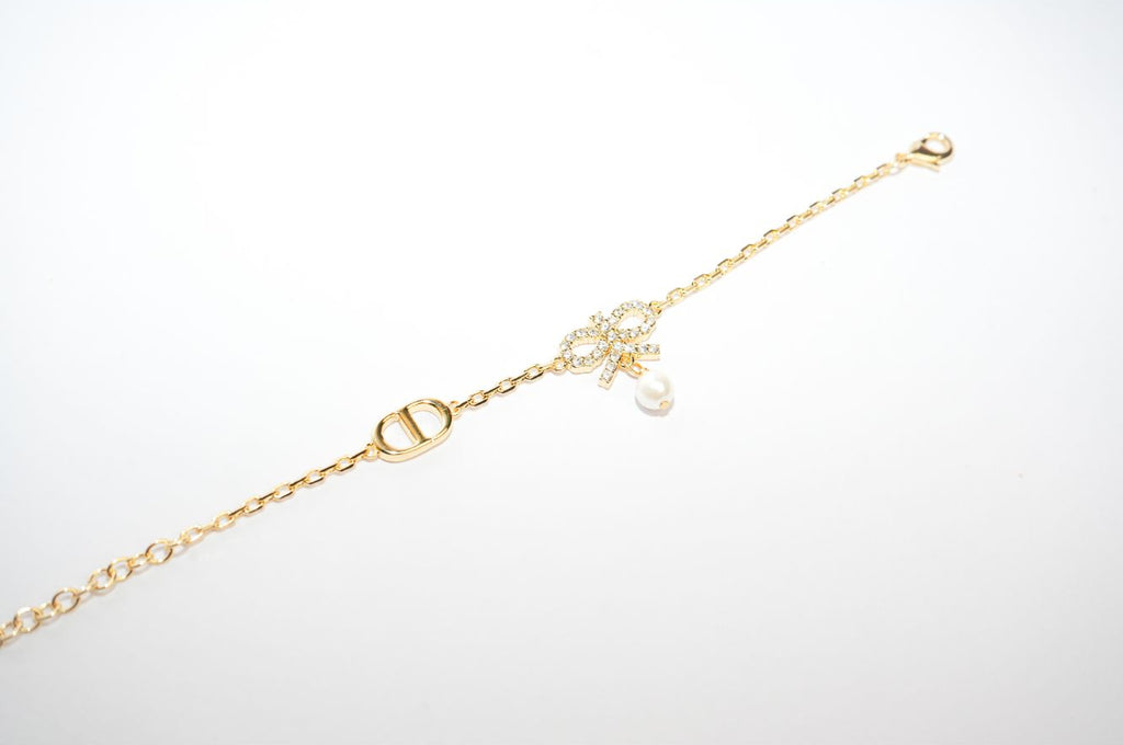 Gold Bow CZ Bracelet with Pearl Charm