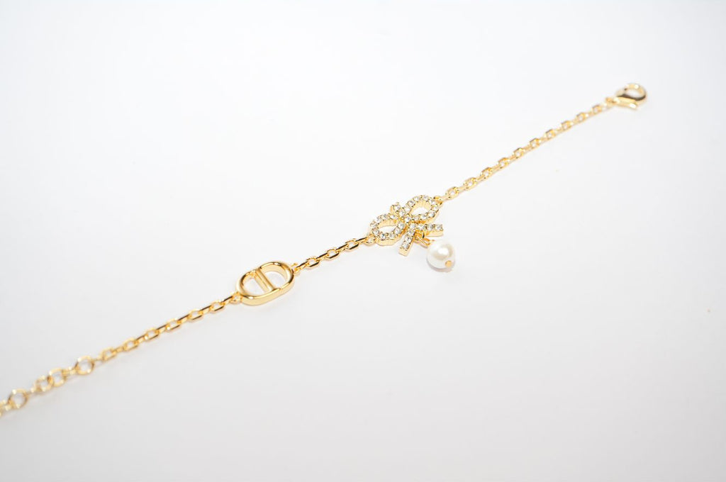 Gold Bow CZ Bracelet with Pearl Charm