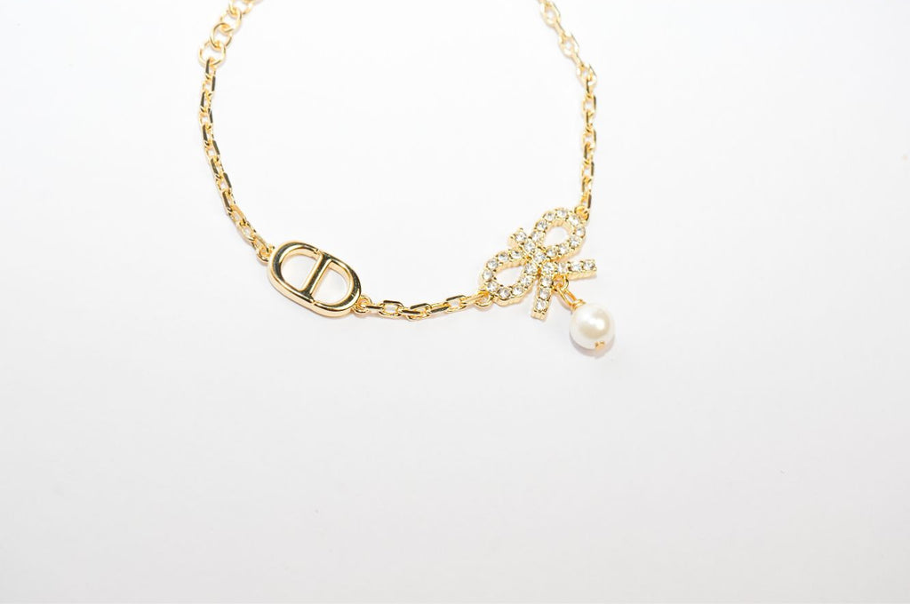 Gold Bow CZ Bracelet with Pearl Charm