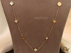 Gold chain necklace with clover motifs