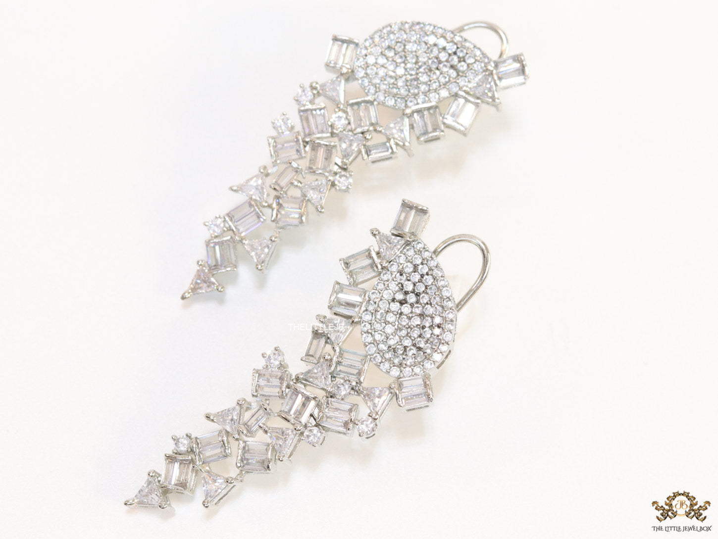 Cz and baguette dangles in platinum finish