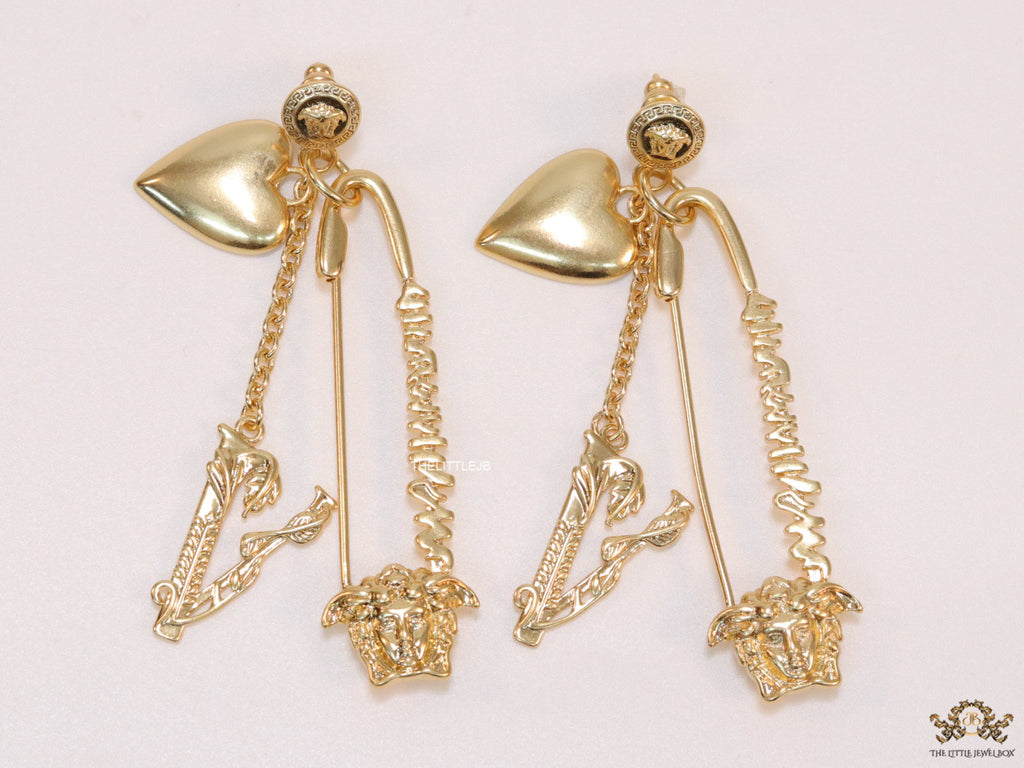 Unique golden Medusa earrings with safety pin motif