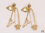 Unique golden Medusa earrings with safety pin motif