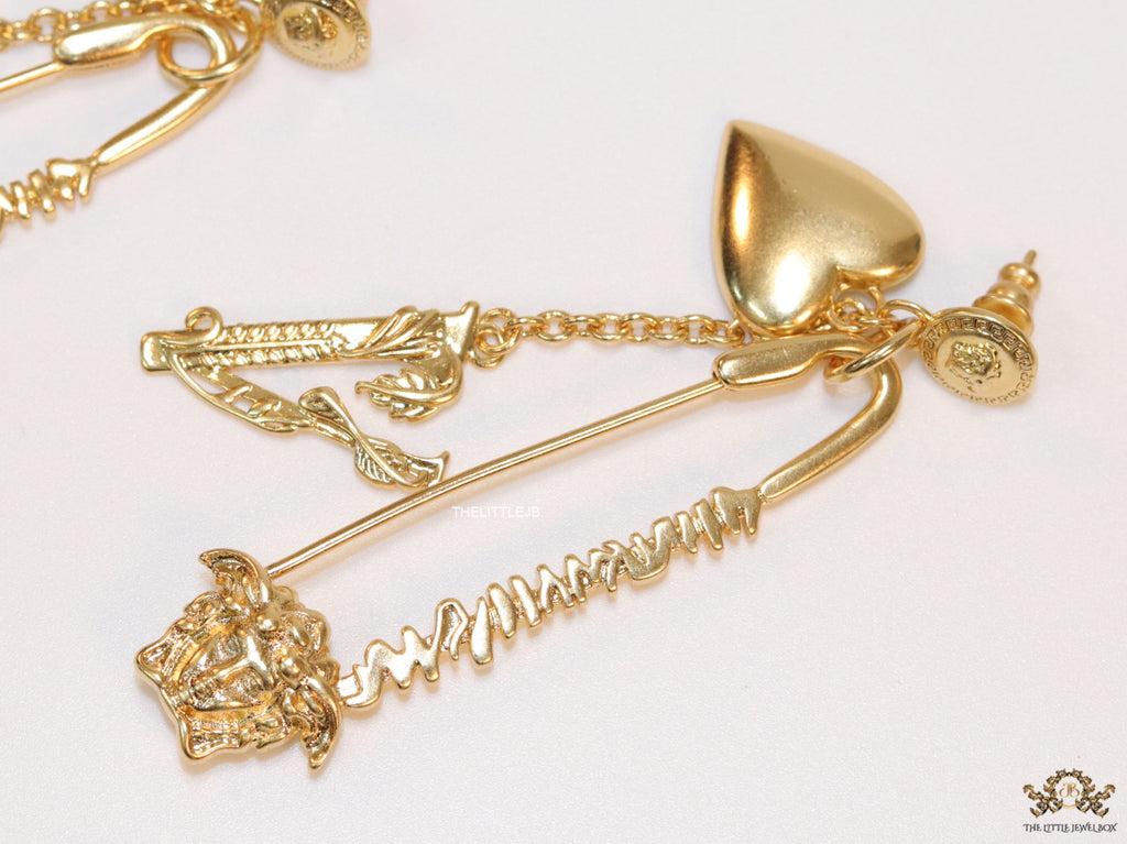 Unique golden Medusa earrings with safety pin motif