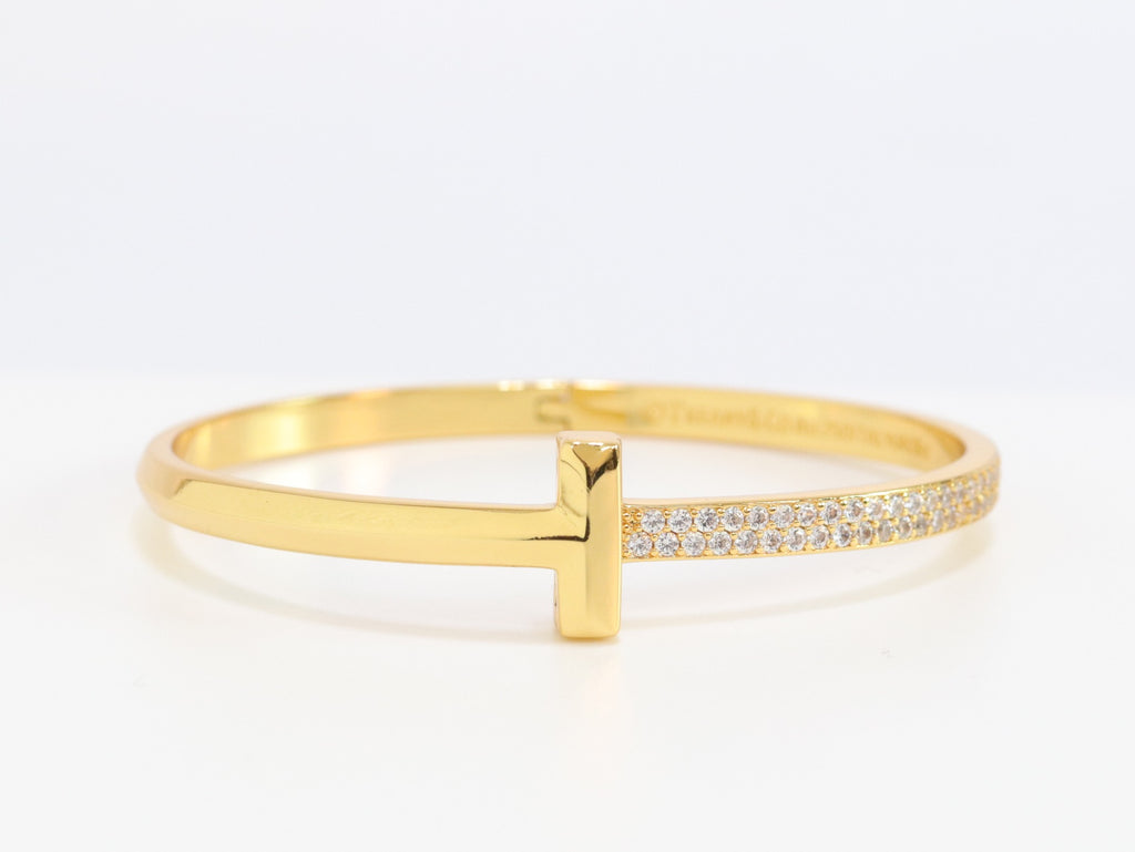 Alphabet T bracelet with half CZ in gold finish