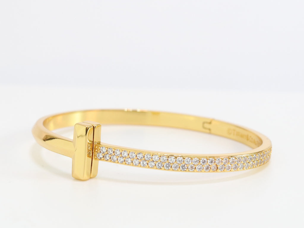 Alphabet T bracelet with half CZ in gold finish