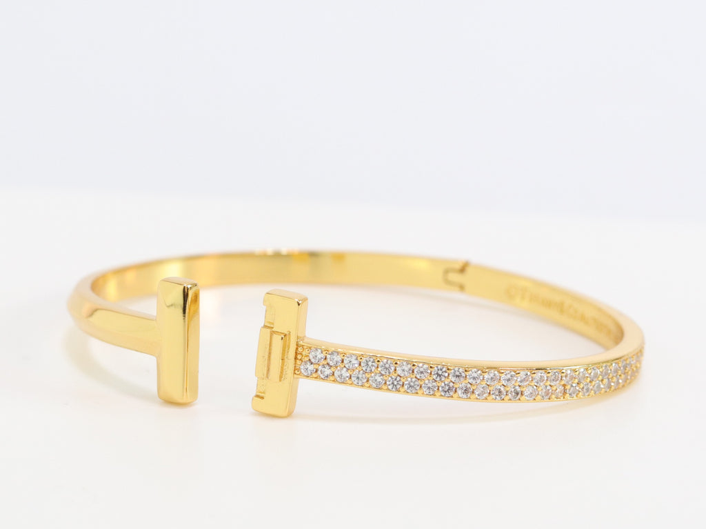 Alphabet T bracelet with half CZ in gold finish