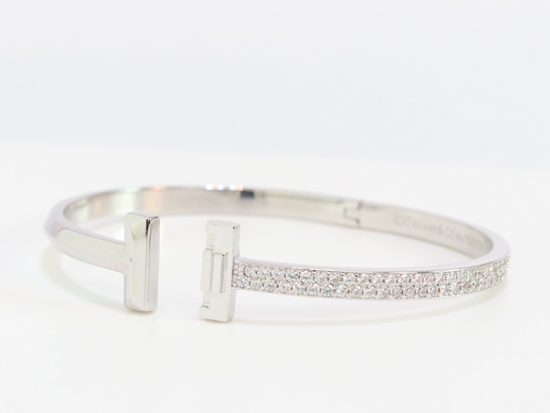 Alphabet T bracelet with half CZ in platinum finish