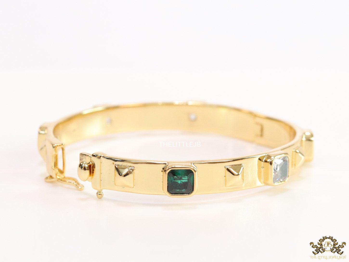 Band style bracelet in gold plating with gold plated details and multi colour stones